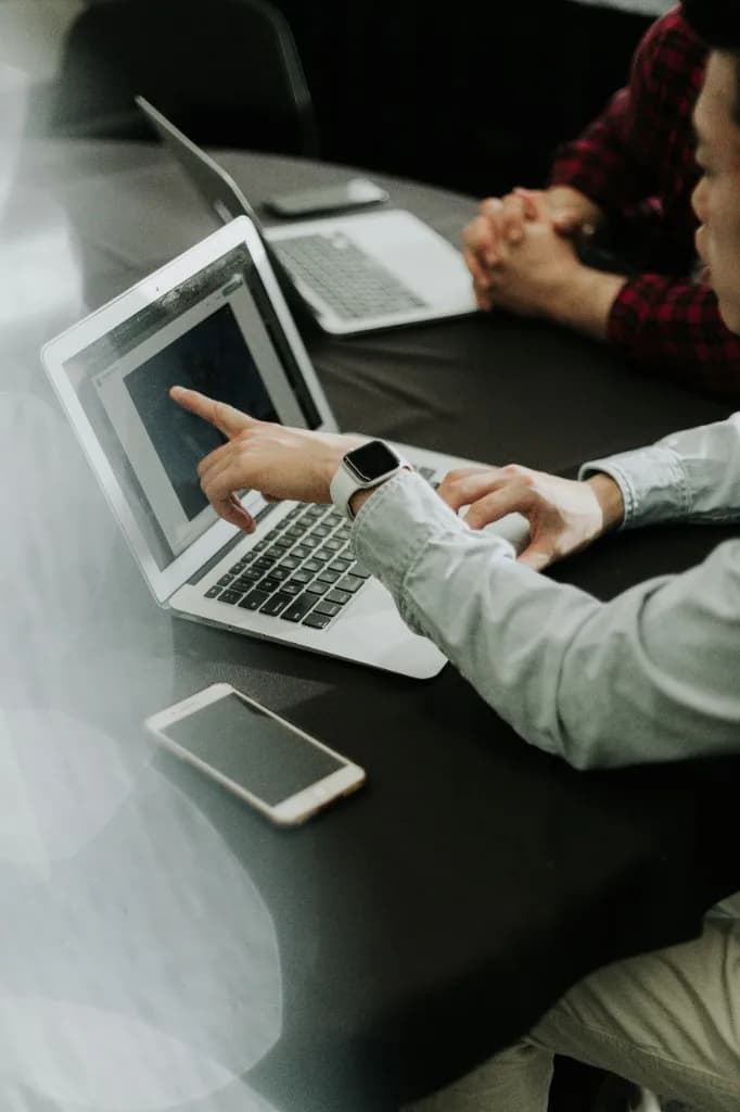 Two people reviewing a laptop screen during a working session